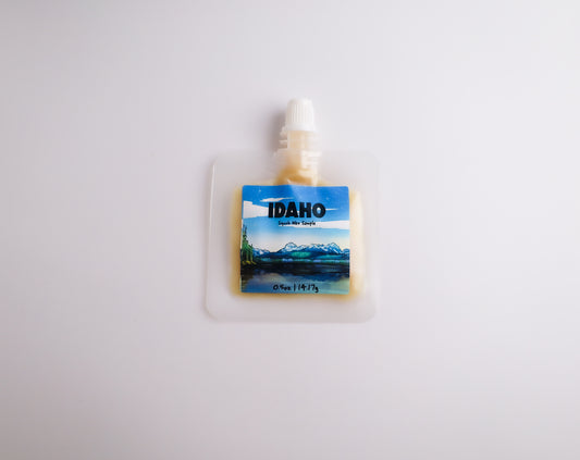 Small pouch with an Idaho scenic label on a white background