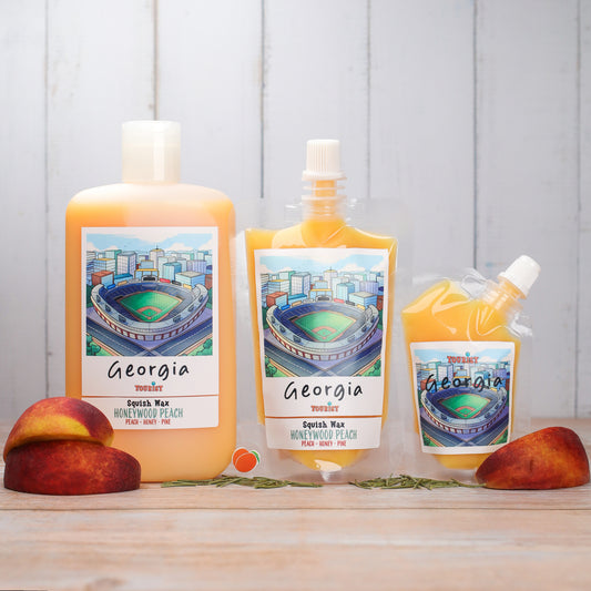 Georgia Squish Wax in Honeywood Peach scent, featuring peach, honey, and pine notes. Three sizes displayed.