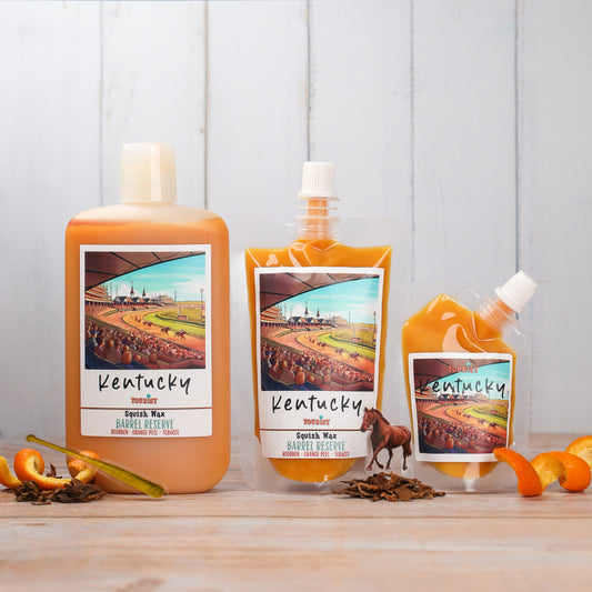 Kentucky Squish Wax Barrel Preserve in orange, featuring bourbon and orange peel fragrance.