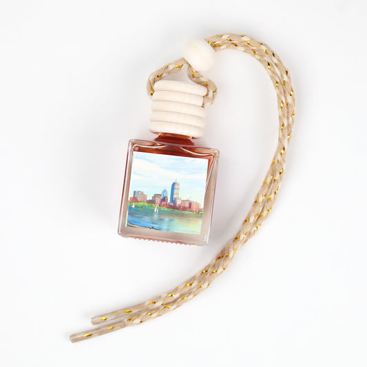 Scented oil bottle with scenic label, square glass, natural wood top, braided beige rope, ideal for home fragrance.