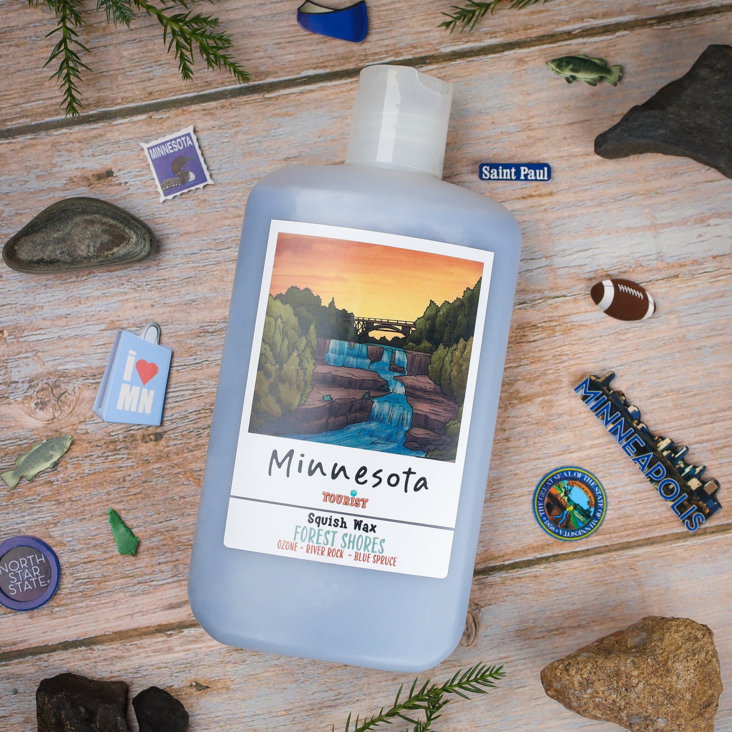 Minnesota Squish Wax in blue bottle, scent: Forest Shores, featuring ozone, river rock, and blue spruce.