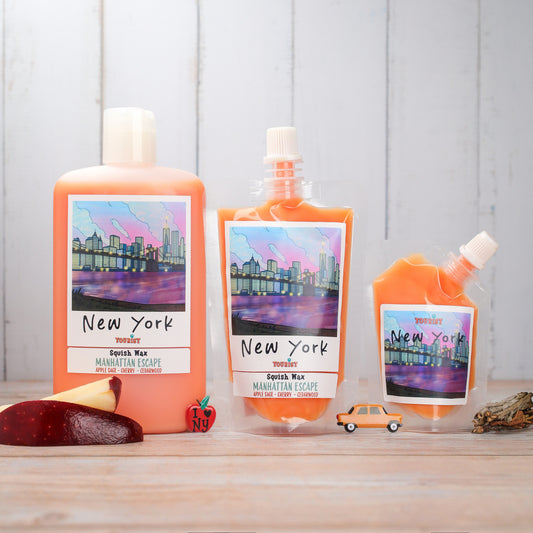 New York Squish Wax set in orange packaging, featuring Manhattan Escape scent: apple sage, cherry, cedarwood.