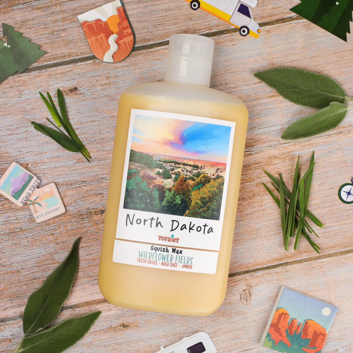 North Dakota squish wax in yellow bottle, scent: Wildflower Fields, features fresh grass, wild sage, and amber.