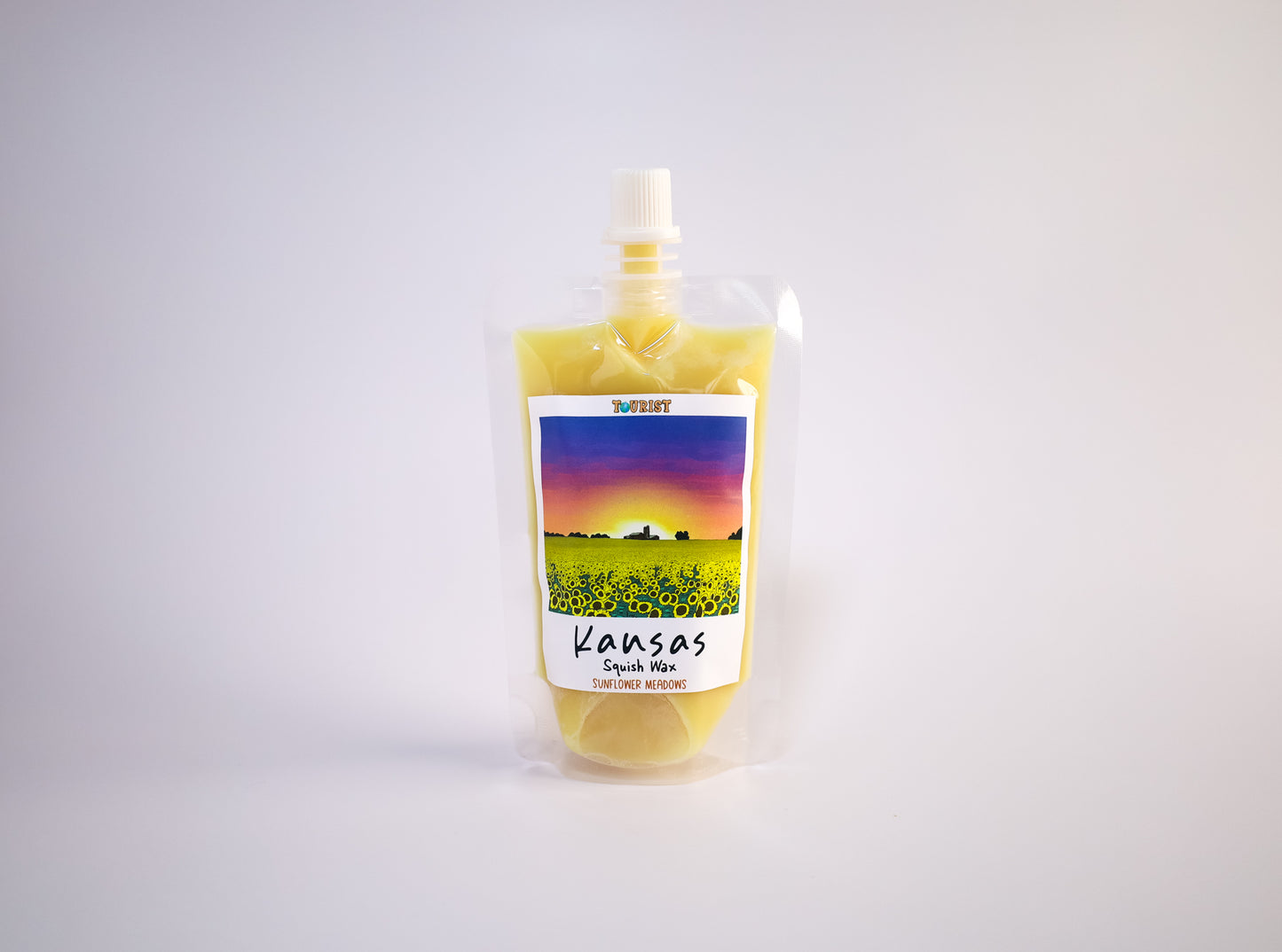 Pouch with a colorful scenic label of Kansas on a white background
