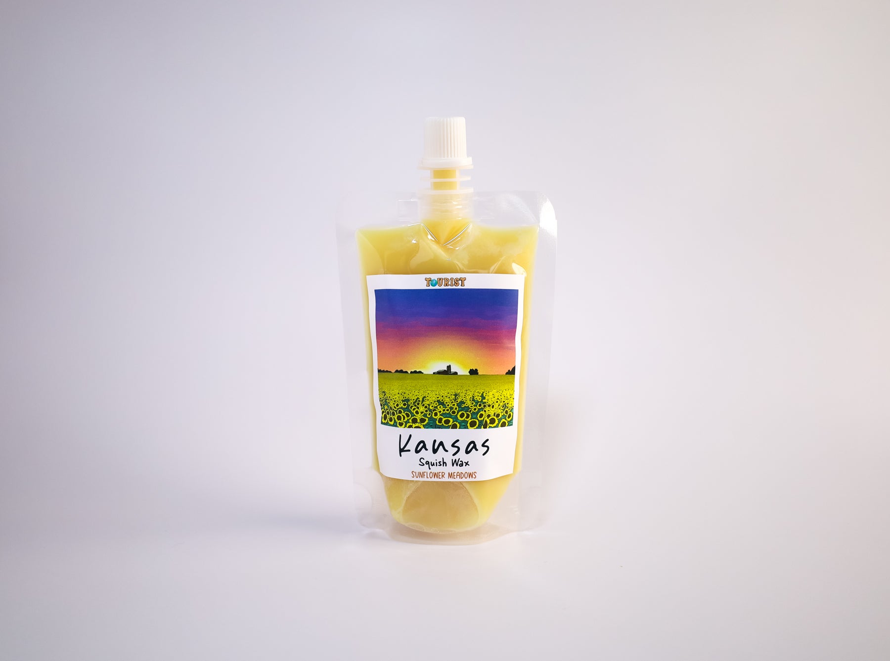 Pouch with a colorful scenic label of Kansas on a white background