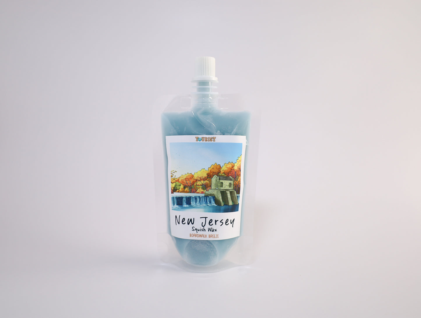 Pouch of squish wax with a scenic label on a white background