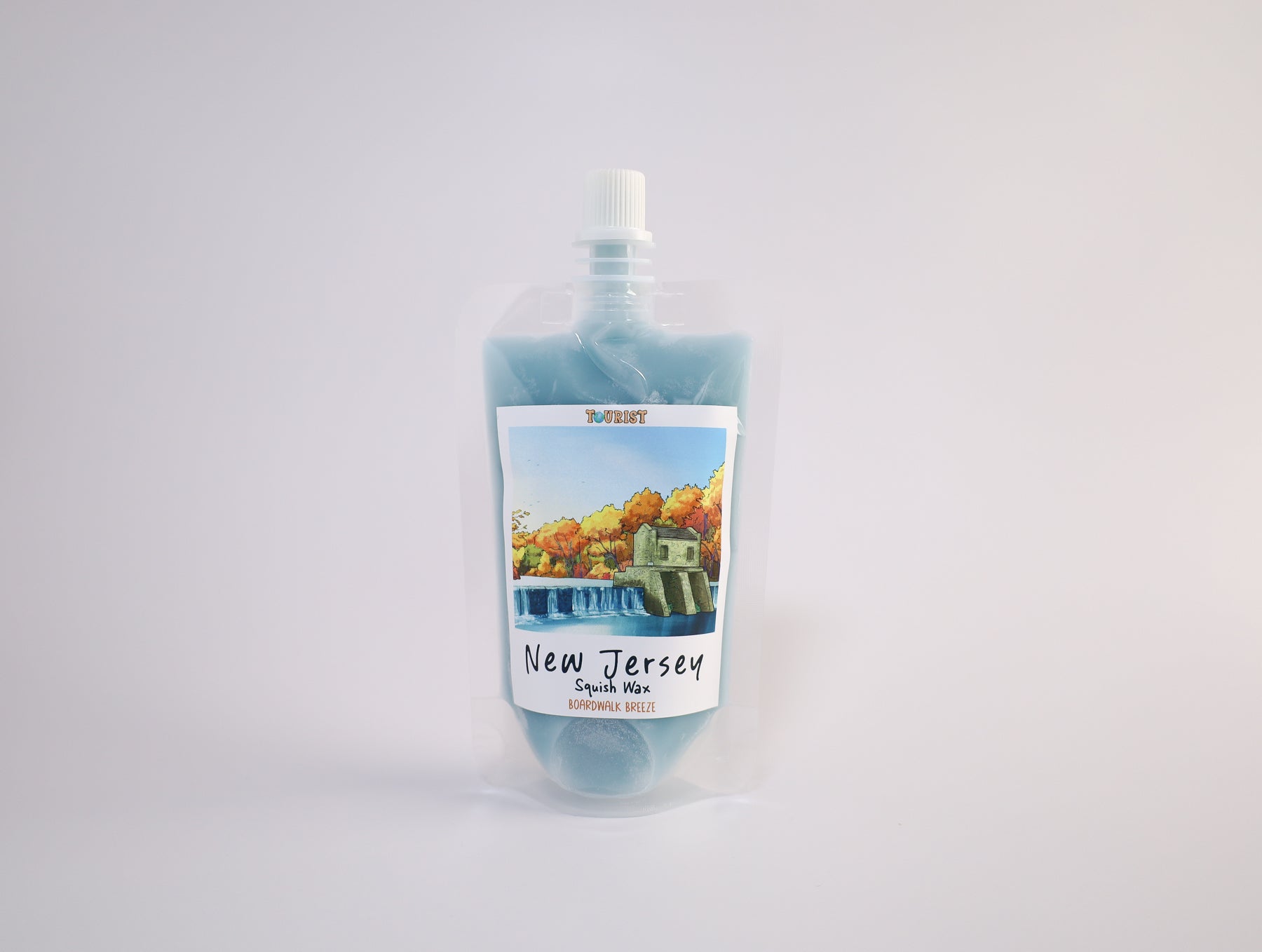 Pouch of squish wax with a scenic label on a white background