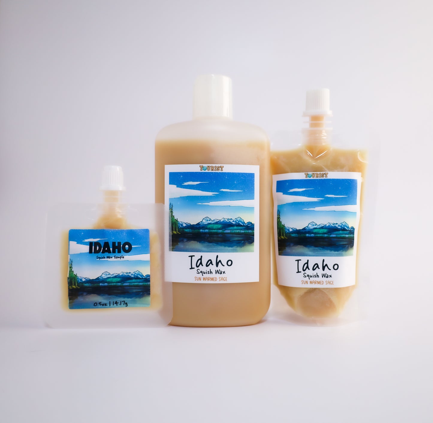 Three sizes of Idaho squish wax with scenic labels on a white background