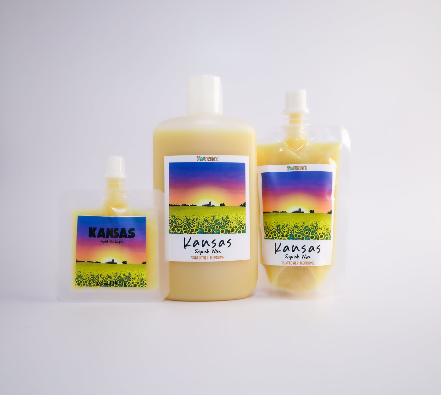 Three 'Kansas' themed sized squish wax products on a white background