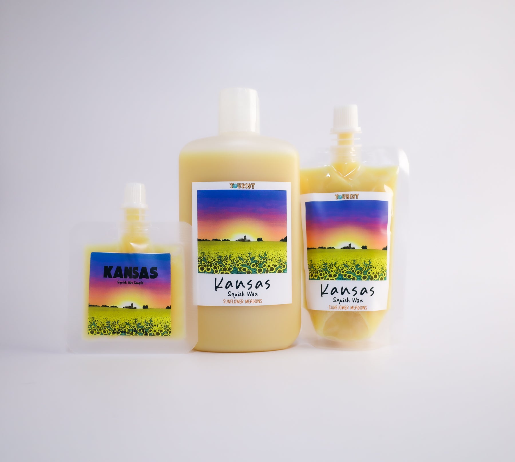 Three 'Kansas' themed sized squish wax products on a white background