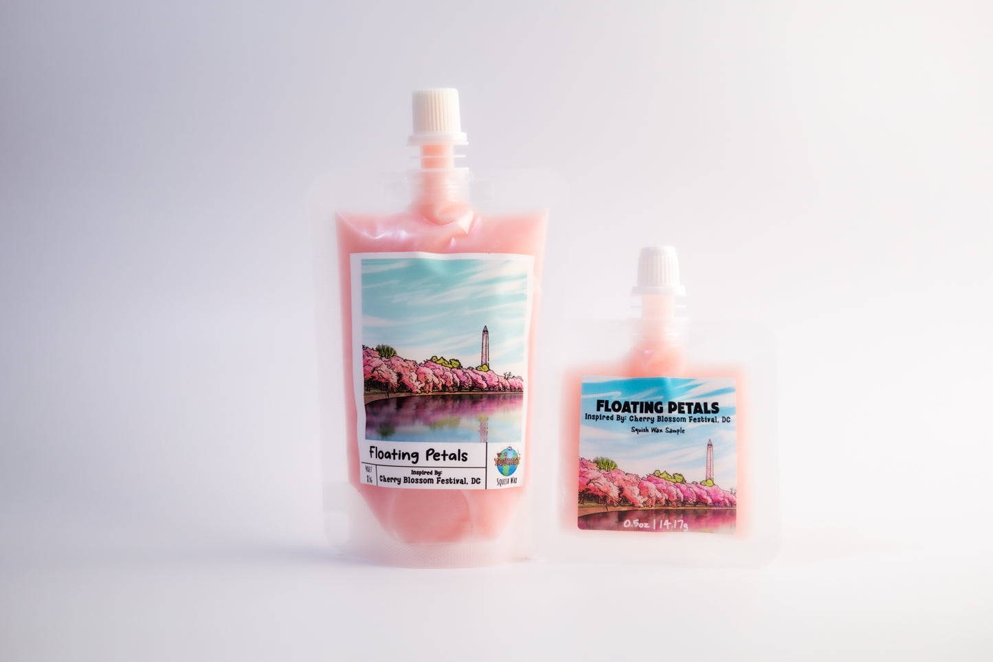 Two bottles of 'Floating Petals' product with cherry blossom imagery on a light gray background