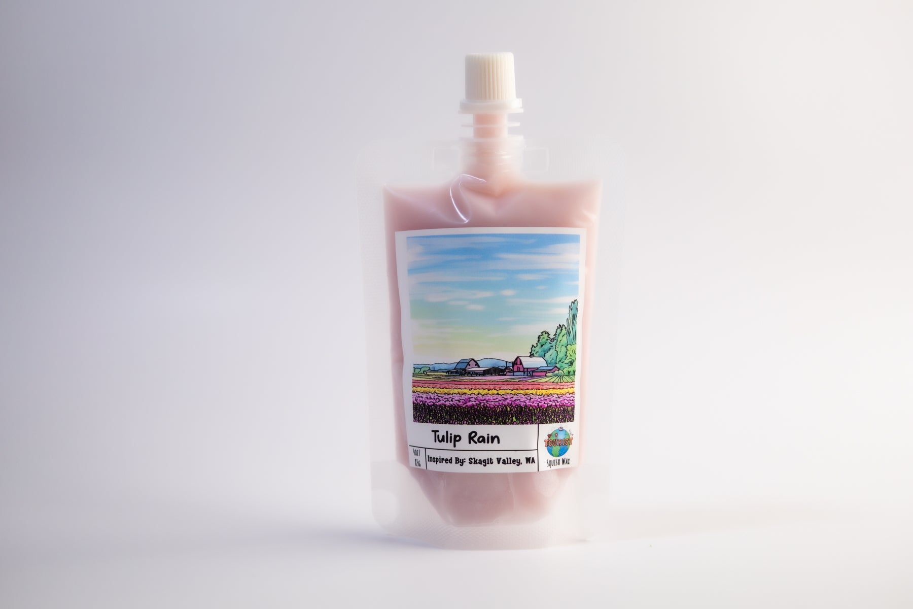 Pouch of Tulip Rain squeezable wax melt with a scenic label on a white background