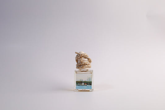 Small glass car freshener with Connecticut themed artwork on white background