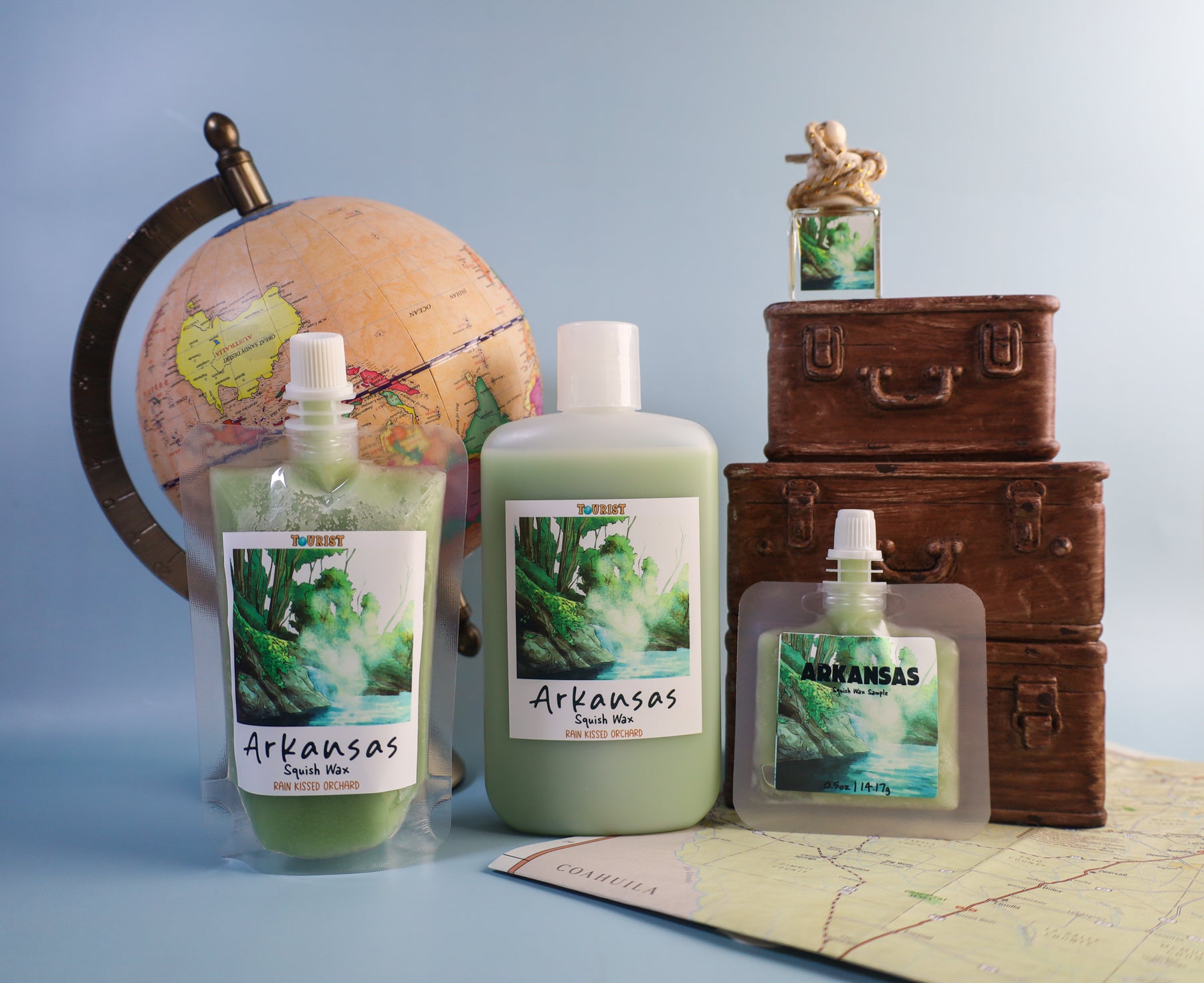 Arkansas scenic label squish wax products with a globe and suitcases on a map background
