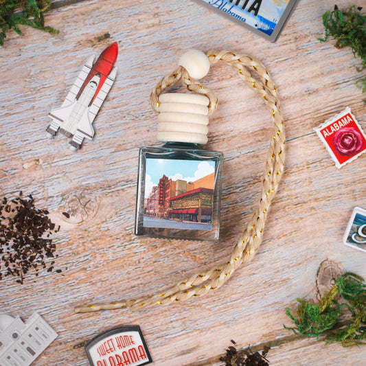 Vintage-style car air freshener in glass bottle with braided cord, featuring a scenic Alabama design.