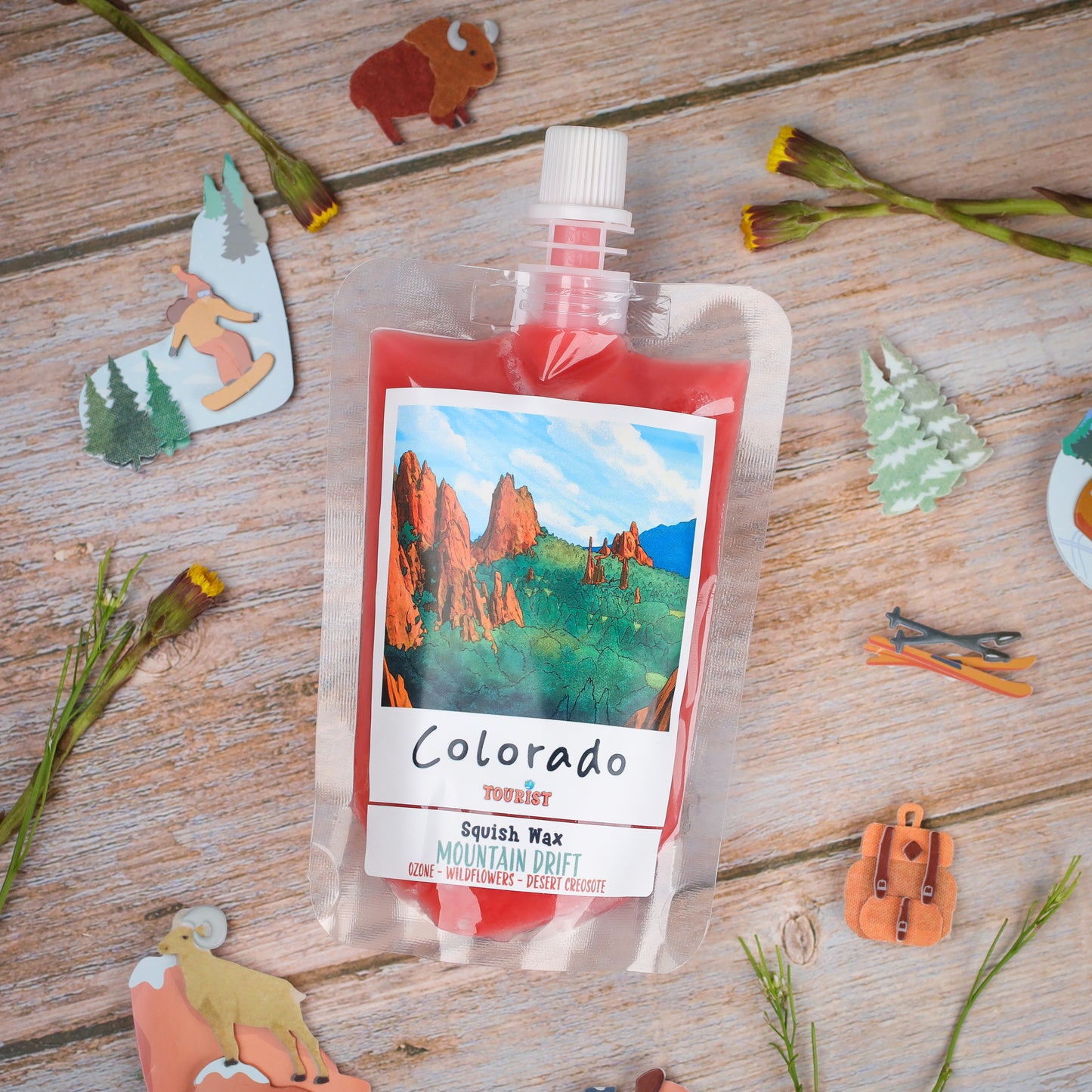 Colorado Squish Wax in Mountain Drift scent, colorful packaging with wildflower and desert notes.