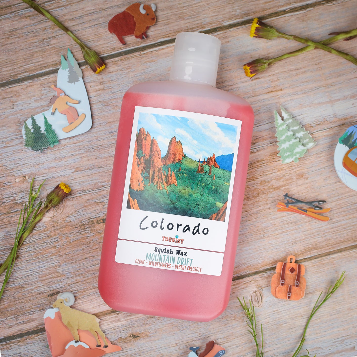 Squish Wax in pink bottle, scent Mountain Drift, featuring Colorado-themed label and nature decorations.