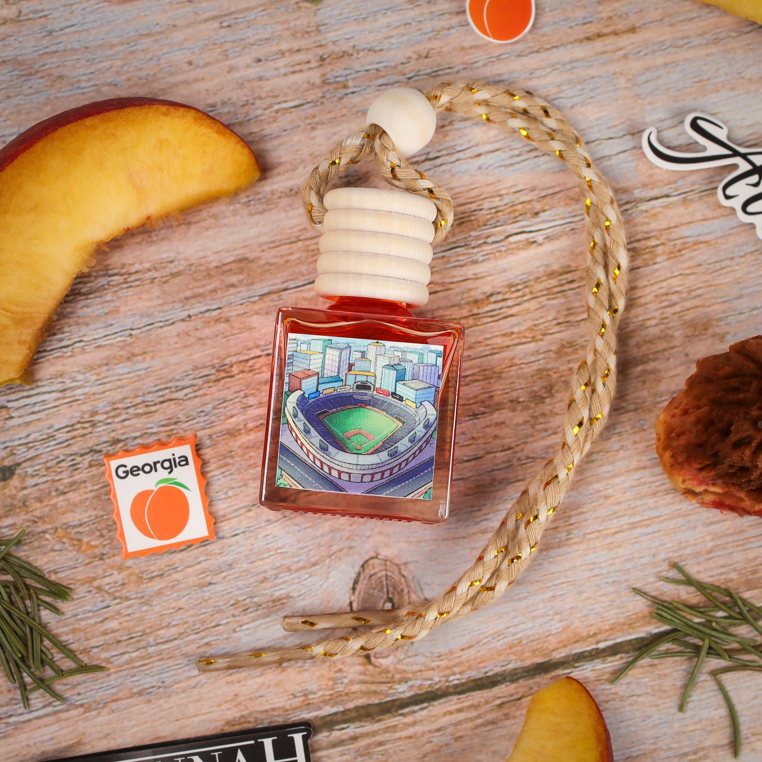 Baseball-themed air freshener, red glass bottle, decorative cap, featuring a stadium illustration.