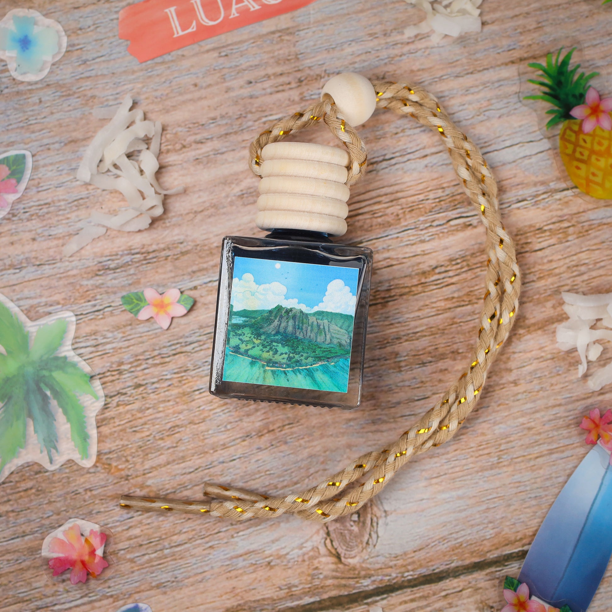 Handcrafted glass bottle with an ocean view print, featuring a wood and braided rope necklace.