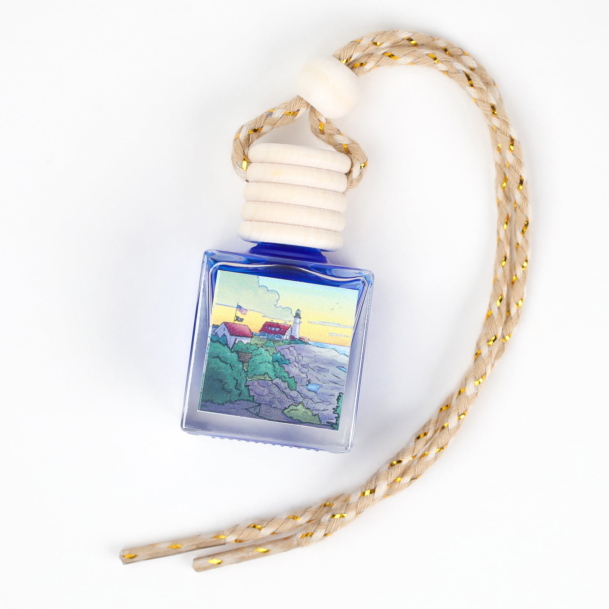 Blue glass fragrance bottle with lighthouse design and braided rope hanger for home decor.