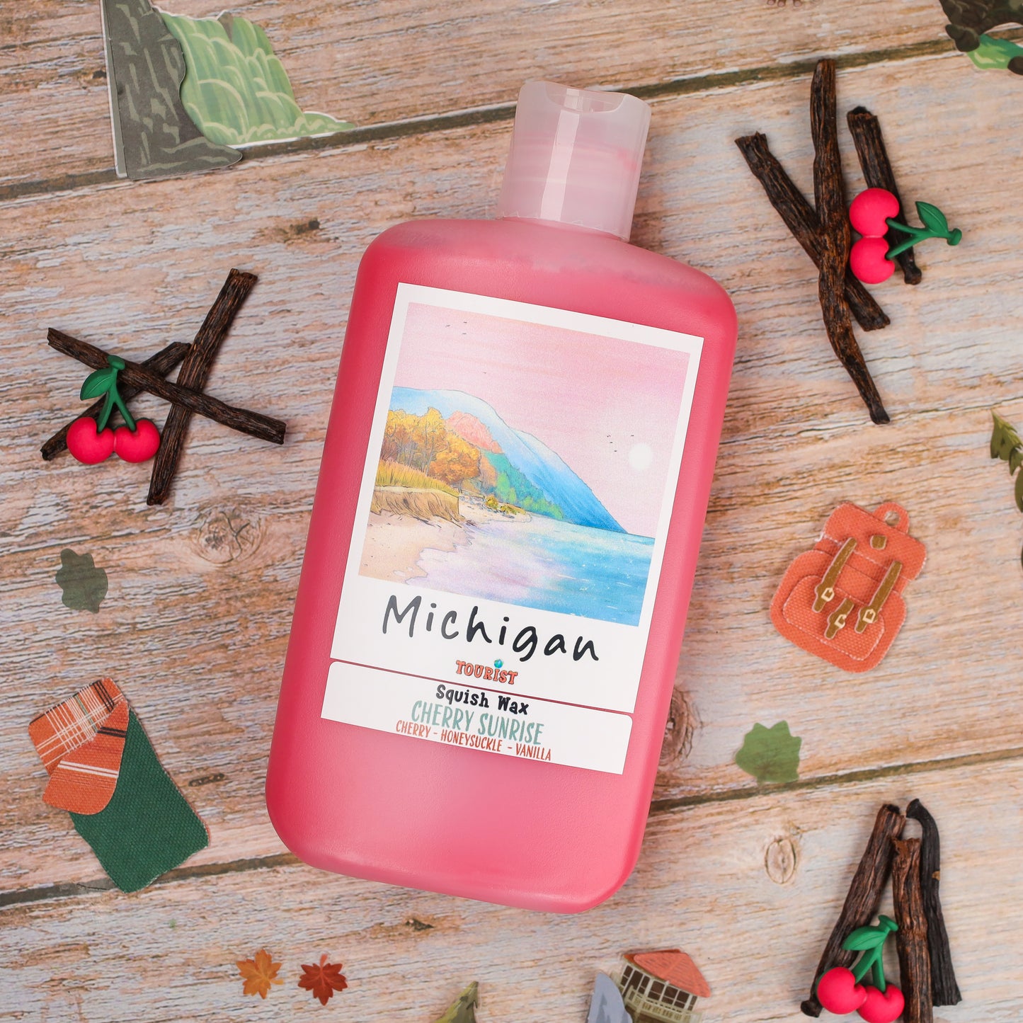 Michigan Squish Wax in pink bottle, Cherry Sunrise scent with notes of cherry, honeysuckle, and vanilla.