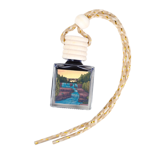 Decorative air freshener bottle with waterfall design, clear glass, and braided rope hanging strap.