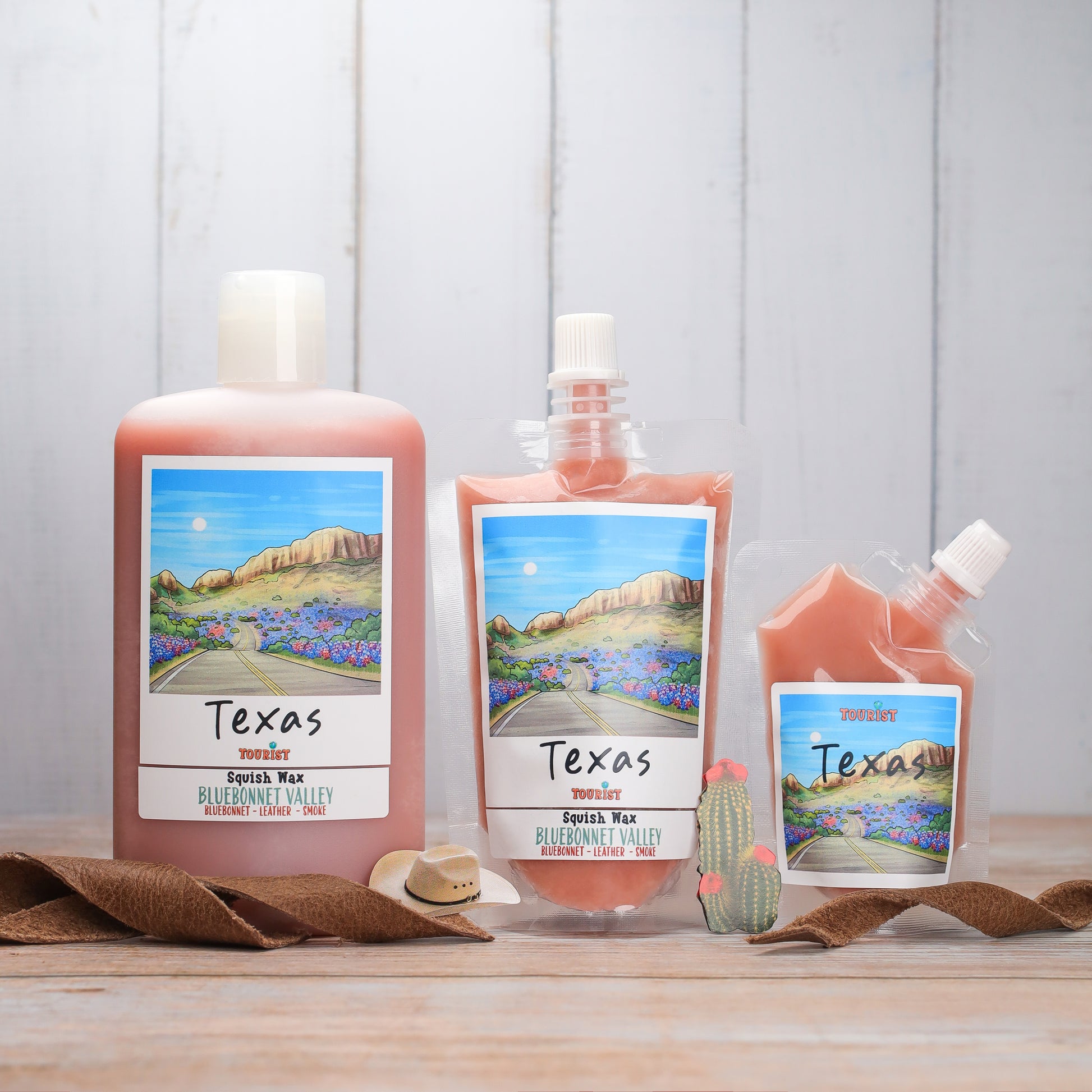Texas Squish Wax in Bluebonnet Valley scent, featuring large and small pouches and a bottle, leather and smoke notes.