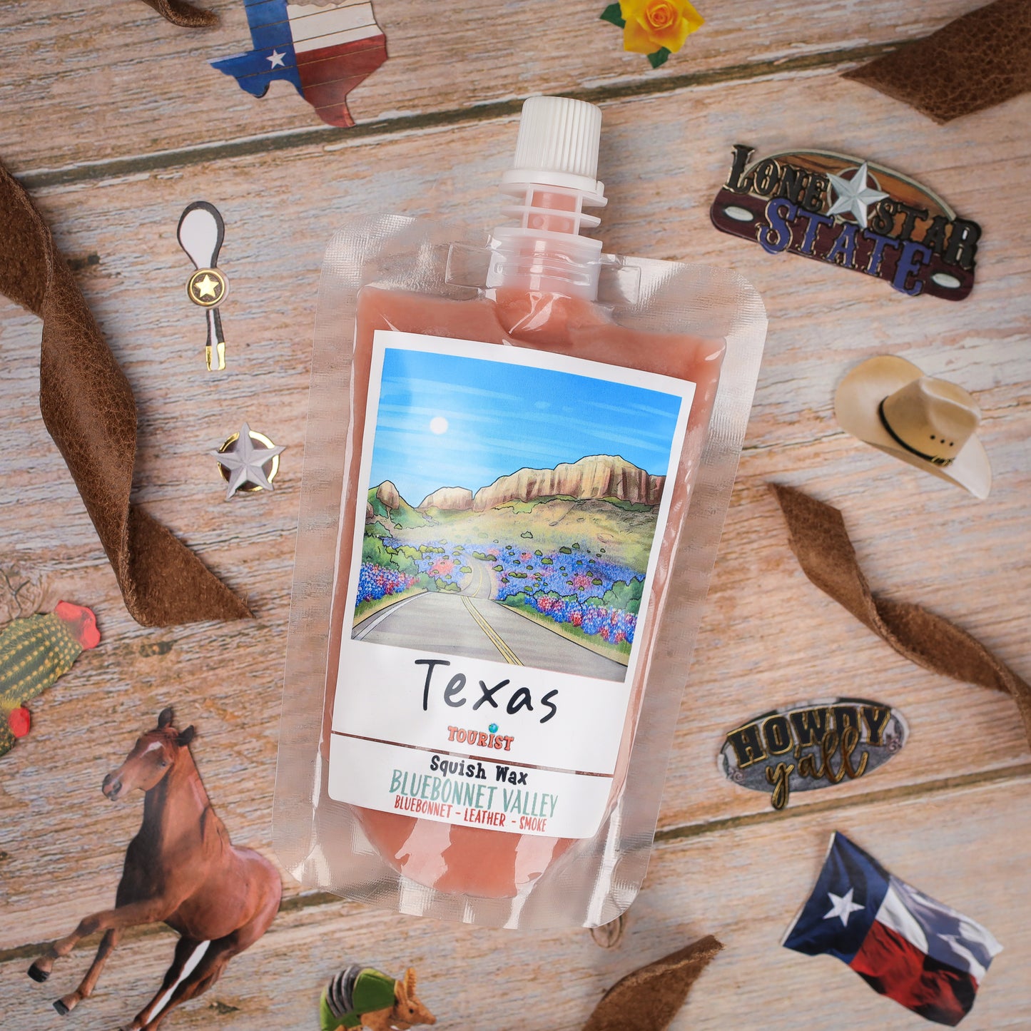 Texas Squish Wax in Bluebonnet Valley scent, featuring a colorful label and convenient pouch packaging.