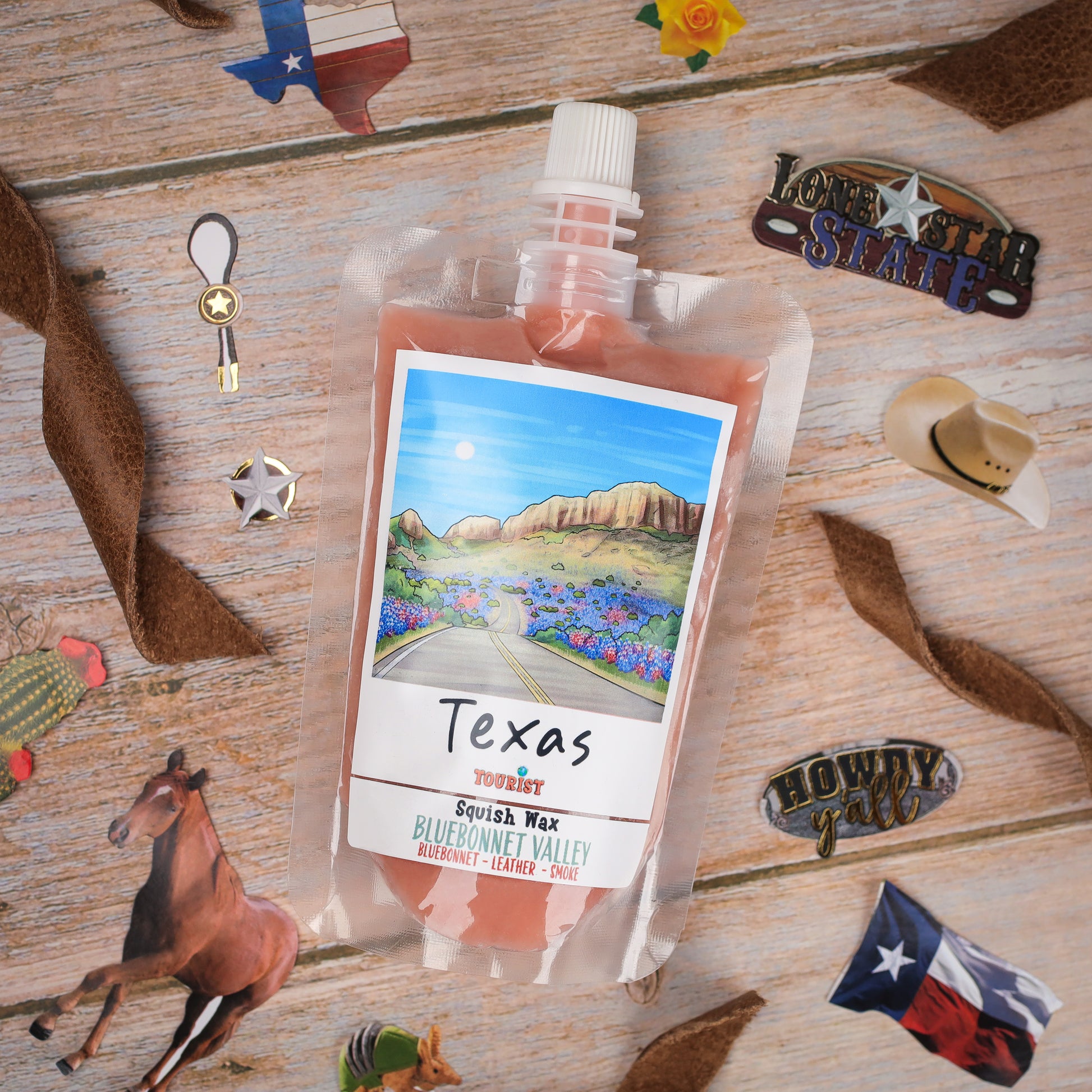 Texas Squish Wax in Bluebonnet Valley scent, featuring a colorful label and convenient pouch packaging.